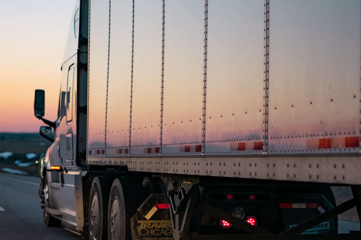 A professional truck driver beside a tractor